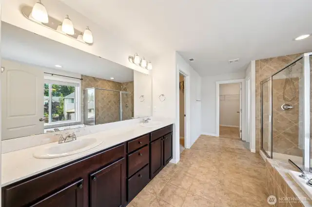 Primary bath with two walk in closets in the distance