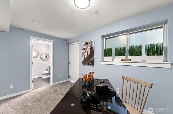 lower level bedroom/den with ensuite bathroom and patio access