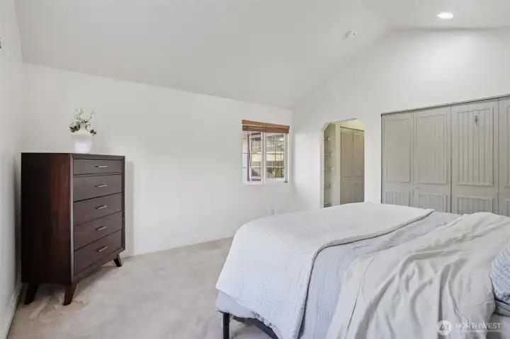 Primary suite with double closets, fresh paint, vaulted ceilings and large en suite
