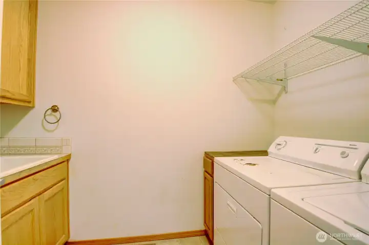 Laundry room is spacious and has a deep sink.