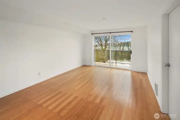 The bright & spacious living room. The door leads to your bedroom.