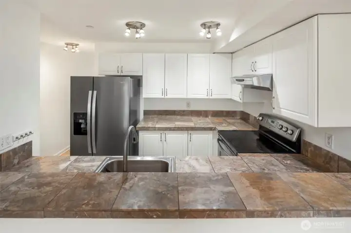 Your kitchen offers a breakfast bar, stainless appliances, and great storage!