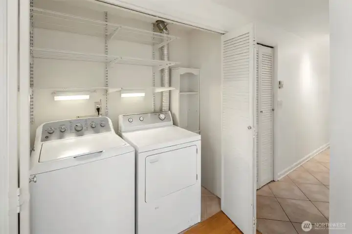The full size in-unit washer/dryer ha great storage in addition to the pantry next to it.