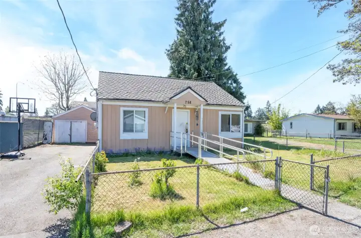 Investor opportunity featuring a home with a detached garage and an expansive 1,520 SF detached shop.