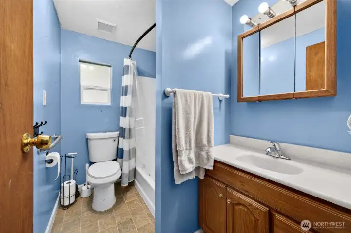 Hallway bathroom with tub.