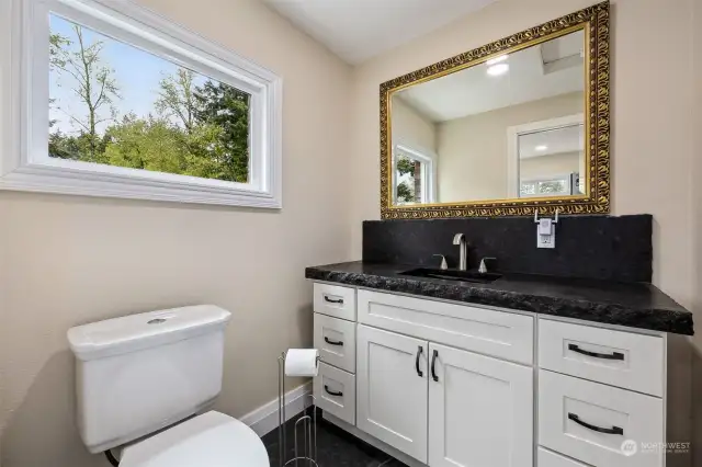 1/2 Bath off Laundry/Mud Room w/Granite Counters and New Cabinets. Wood-Wrapped Windows!