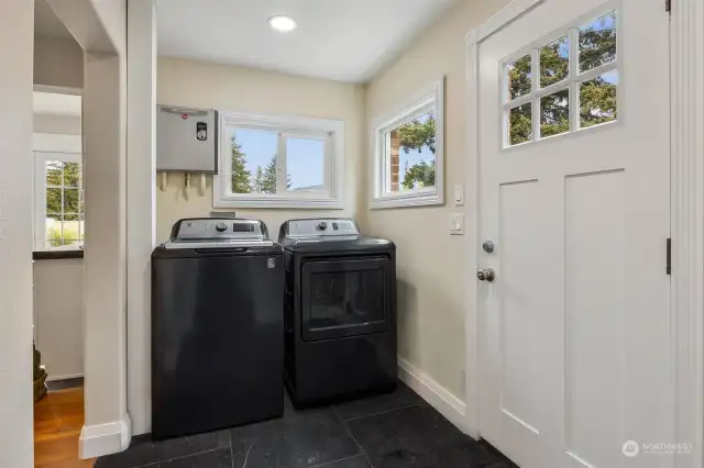Laundry/Mud Room: Tile Floors. Door to Side Yard toward Garage and DADU. GE Black Stainless Washer and Dryer Stay!