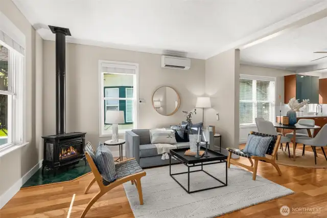 Living room features engineered hardwood floors, new mini splits, and a cozy wood stove.