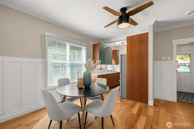 Large dining room with a new modern fan/light fixture.