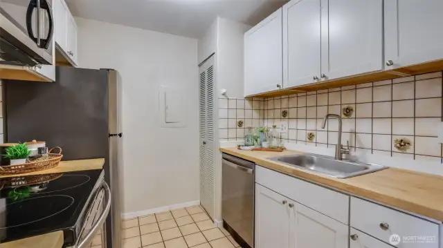 Closet in the kitchen plus cabinets providing plenty of storage space.