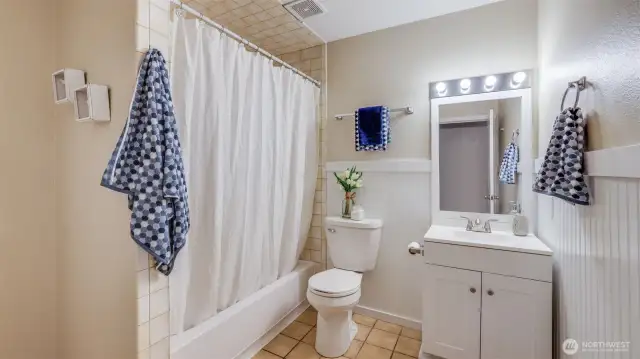 This well appointed bathroom is open and spacious with room for a storage cabinet too!