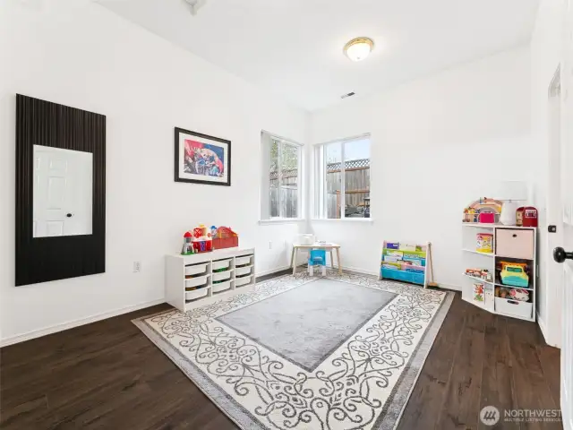 Gleaming wood-laminate floors extend into the 2nd Primary bedroom/Junior Suite on the main level.