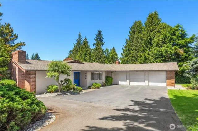 Stunning home with turnaround driveway. Three car garage.