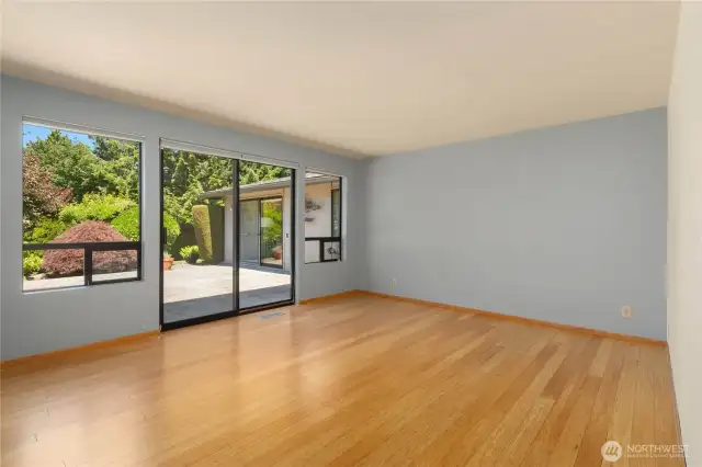 Primary bedroom looks out to patio.