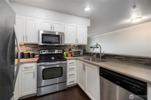 Quartz countertops and stainless steel appliances.