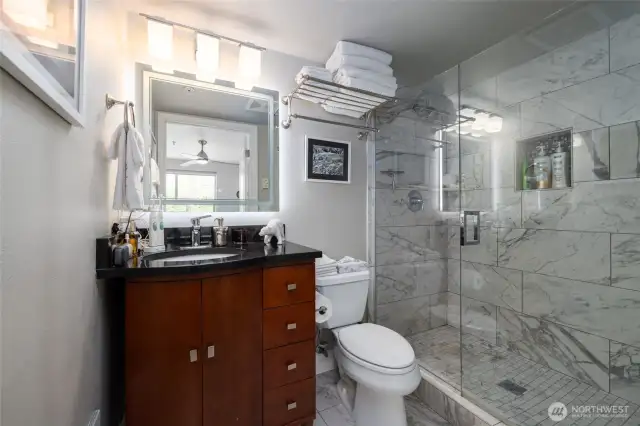 Primary bath has an updated walk in shower and vanity.