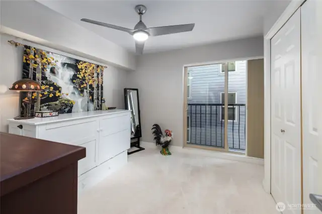 The spare bedroom has a juliette balcony with a sliding door to allow ample natural light and fresh sea air into the unit.