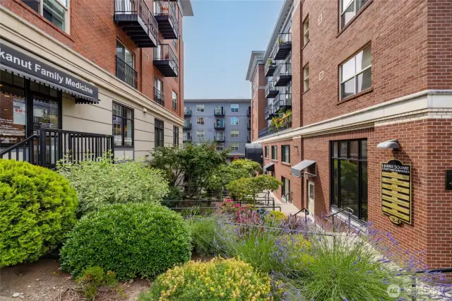 Beautiful landscaping surrounds the building.