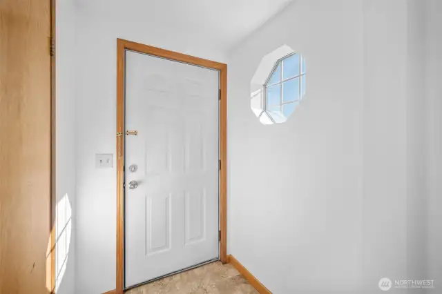 Inviting interior entryway with a handy coat closet and warm, welcoming feel.