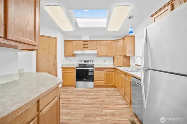 Clean, well-quipped kitchen with plenty of workspace and natural light.