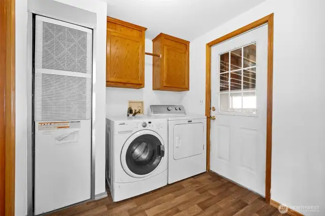 Utility room is located off of the living room and connects to the garage.