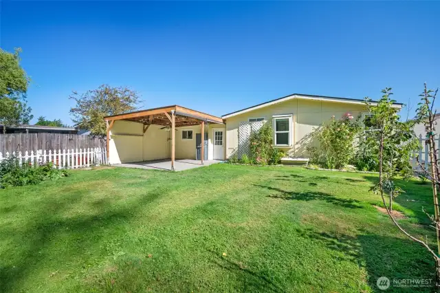 Peaceful backyard with dedicated gardening areas and room to relax.
