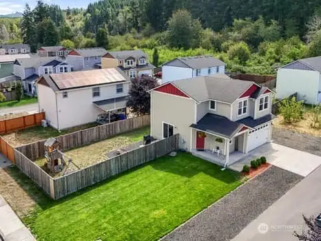 Aerial view of home and lot.  Parking in front, side and next to home.  Large fence area that wraps around back and side of home.