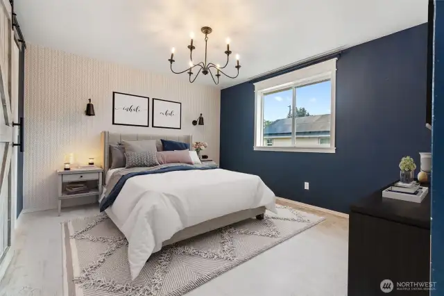 **Virtual Staged**Primary is accented with navy blue and white walls, natural white washed floors throughout the upstairs are unique to this home.  Large window offers great view and natural lighting.  The wall lights on the wall are for decor purposes only, they are non functional.