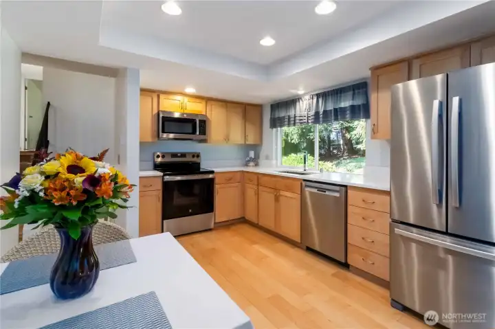 Well-appointed kitchen featuring warm wood cabinetry and sleek modern updates.