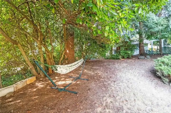 This backyard offers so much versatility for lounging, gardening, or enjoying quiet moments surrounded by nature.