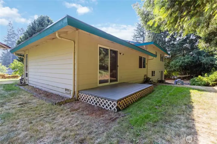 Enjoy this cozy backyard deck with space to relax and enjoy the peaceful surroundings.