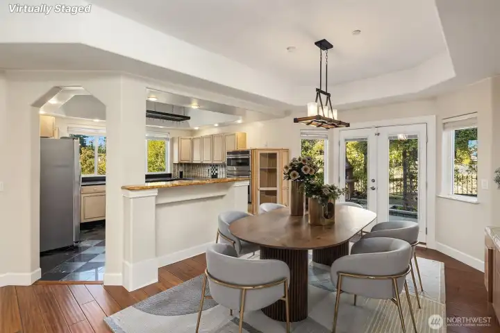 Inviting formal dining area, opening to kitchen and entertaining patio. Virtually staged.