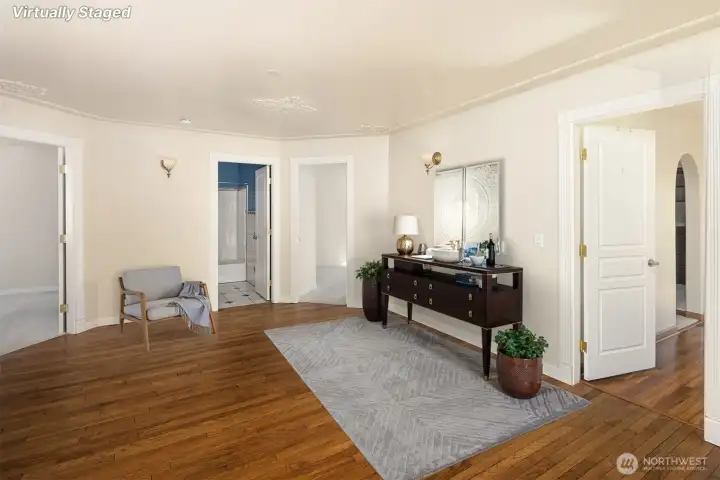 At the top of the grand stairwell, a spacious atrium connecting all 4 bedrooms, and the laundry area. Virtually staged.