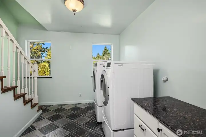 Laundry room on bedroom level, with washer/dryer and granite counter for folding clothes. Stairwell up to recreation/hobby room on 3rd floor.