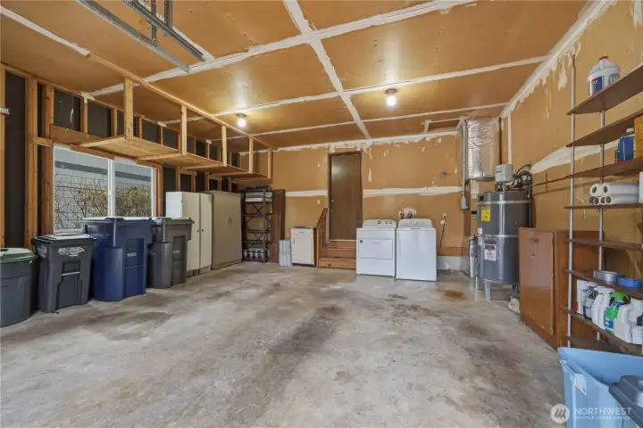 2-car attached garage with extra storage space & shelves. Washer & Dryer (2022) included. Water heater installed 2023.