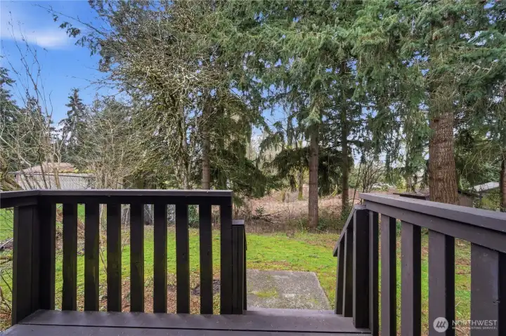 Back porch leads to private backyard that is ready for your plans.