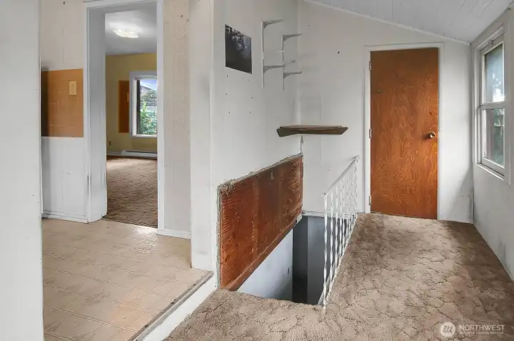 Dining nook off kitchen with stairs to partially finished spacious basement.