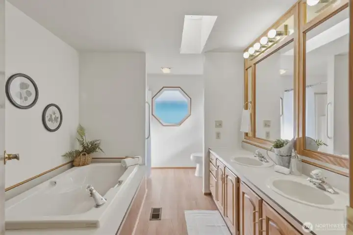 Lovely primary ensuite bathroom with skylight.