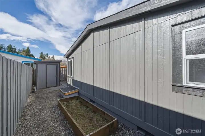 A raised garden bed for your green thumb, plus a storage shed!