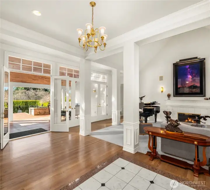 The entry features three sets of French doors opening to seamless, opulent entertaining.