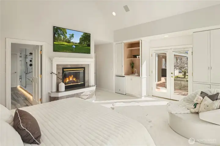 The main-level primary suite soars with natural light and features one of three fireplaces to keep you cozy warm throughout the year.