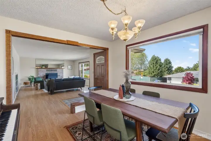 Dining room view toward the living room, with large picture windows.