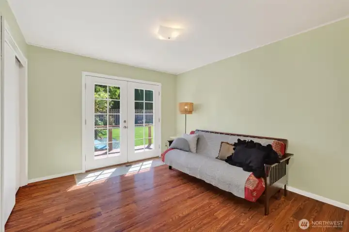 3rd bedroom with french doors to back yard.