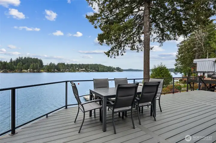 This view is pure Pacific Northwest lakefront magic. Looking out across Mason Lake from this west-facing property, you get the kind of sunsets people start timing dinner around. The water shifts colors all evening long, and from the deck the whole scene feels wide open and incredibly peaceful. The home itself balances beauty with practicality too, thanks to durable HardiePlank siding built for longevity and a built-in sprinkler system helping keep the grounds lush with minimal effort. Because nobody buys a waterfront house hoping to spend every weekend obsessing over yard maintenance. This setup lets you spend more time enjoying the lake, the sunsets and that spectacular deck, and a lot less time hauling sprinklers around the lawn.