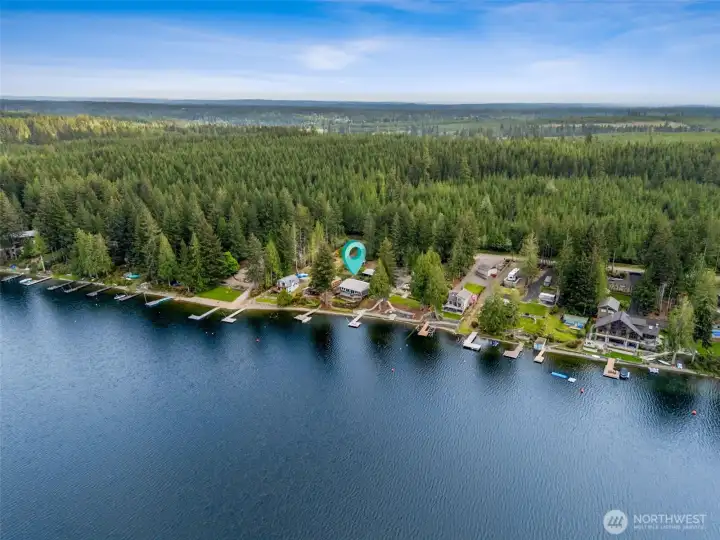 You can see how the home lines up beautifully along the shoreline with neighboring waterfront properties while still feeling wrapped in nature thanks to the surrounding timberland stretching across the hills beyond. It gives the whole area that classic Pacific Northwest lake atmosphere, peaceful, scenic and just rugged enough to feel like an actual escape from city life. Then spread out in front of you is mile after mile of Mason Lake fun, boating, swimming, paddleboarding, fishing, sunset cruises, all of it right outside your door, and if somebody in the household prefers fairways over wake trails, Lake Limerick Golf Club is only about 10 minutes away for an easy round of golf close to home.