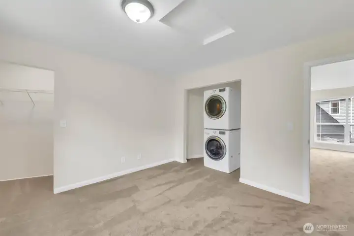 Apartment bedroom with laundry.
