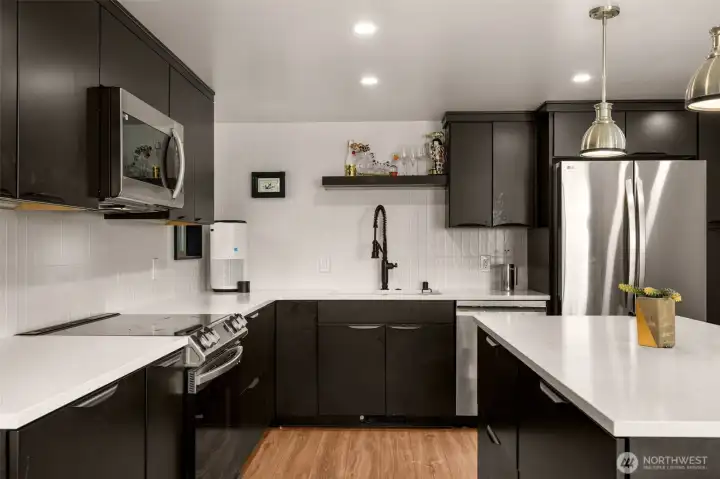 Matte black cabinets, slab counters, custom tilework