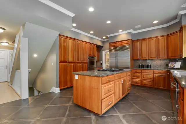 This kitchen is a chef or baker's dream!  Two wall ovens, two large sinks, plus a vegetable sink, gas cooktop, heated floors, and easy access to the formal dining room and the casual dining breakfast room.  So many cabinets for all your storage!