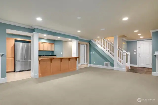 The lower level kitchen has all you need for sports or gaming parties, or a space for long-term guests.  There's no stove or cooking appliances, and plenty of room to add one.  Another gas fireplace (four total in the house) is to the left of the photo.