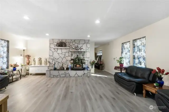 Substantial living room off of entry with double sided fireplace.